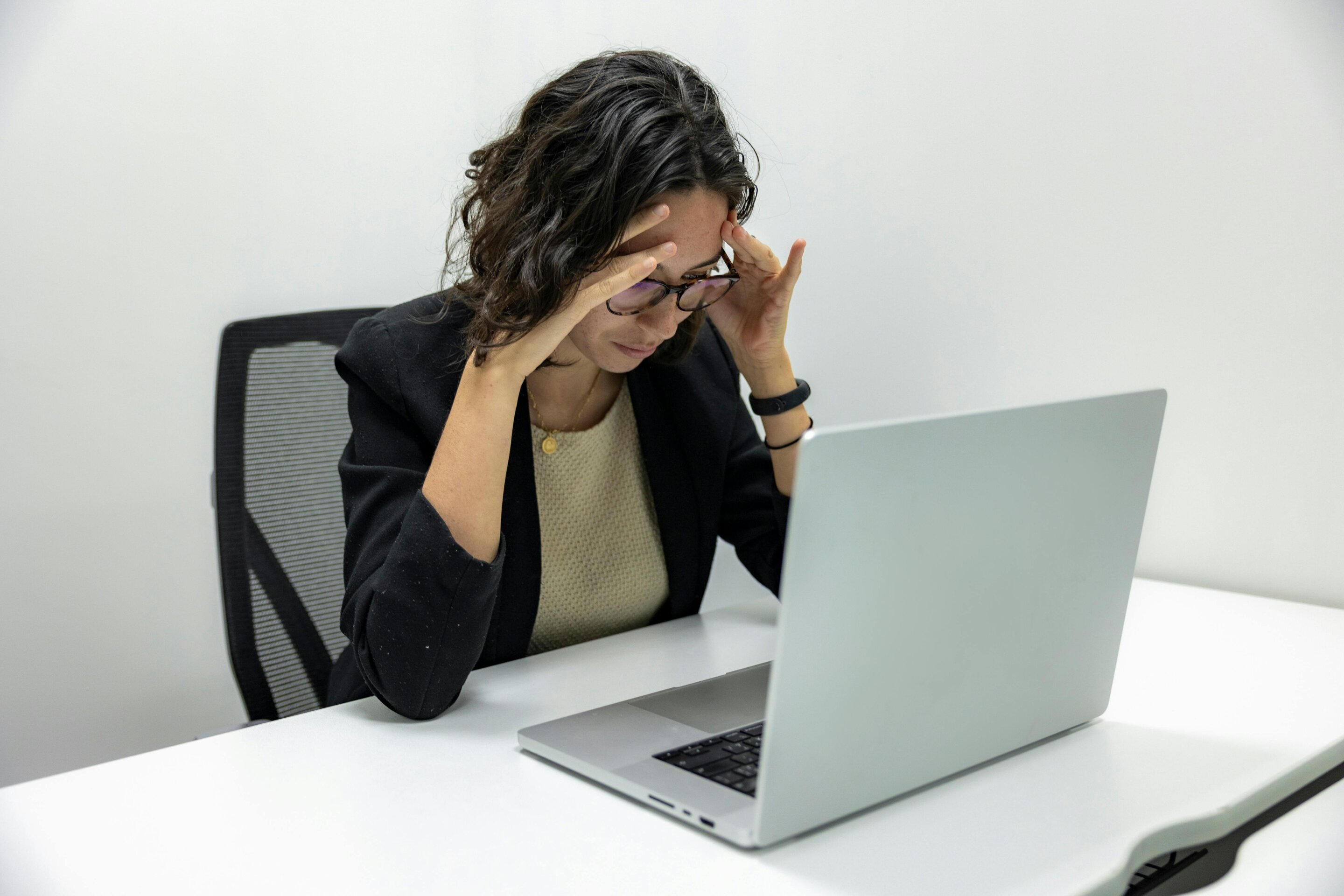 Woman at work experiencing stress — illustrating the challenge of managing menopause symptoms in the workplace