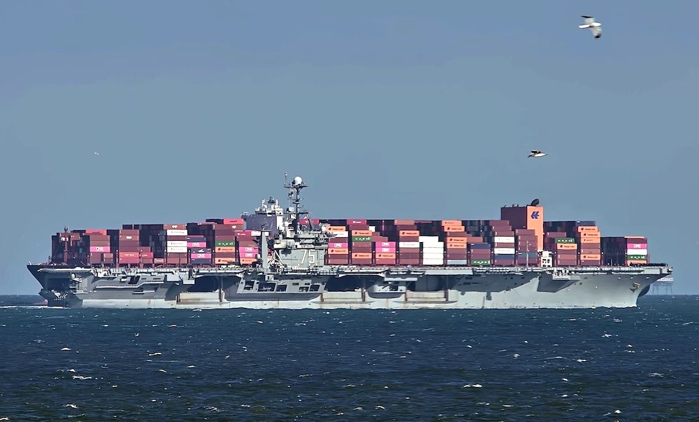Container ships alongside a naval vessel, illustrating geopolitical pressures on shipping