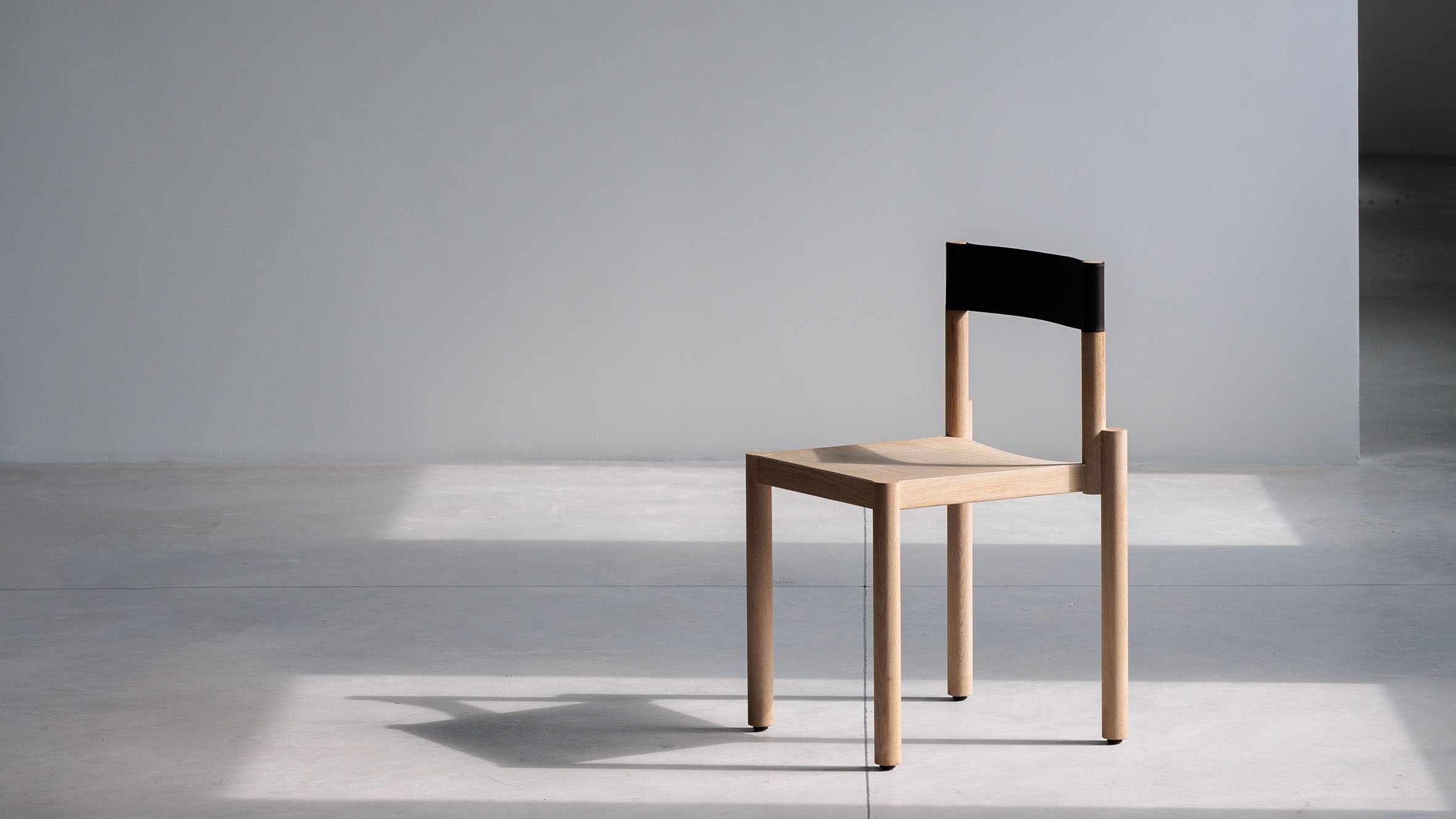 Adinne chair by True Design with leather and wood construction