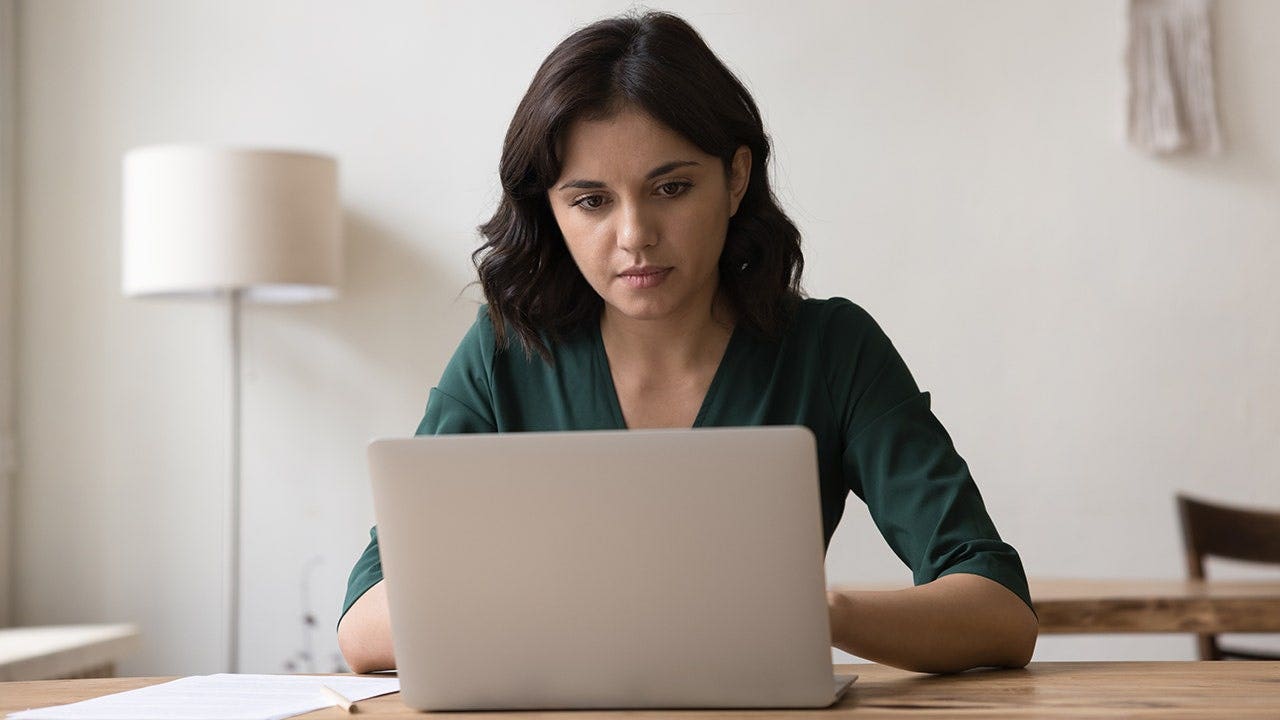 Image showing freelance worker at desk with notification of data compromise