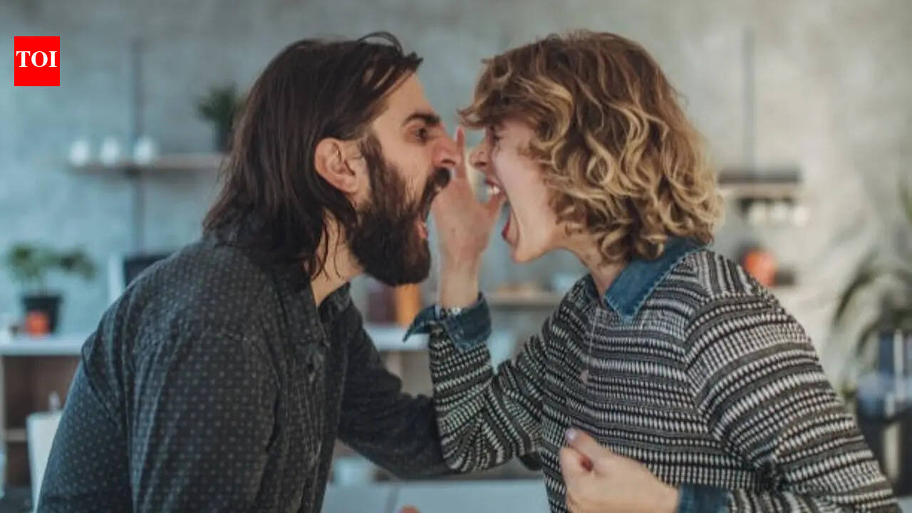 Couple sitting apart in a living room