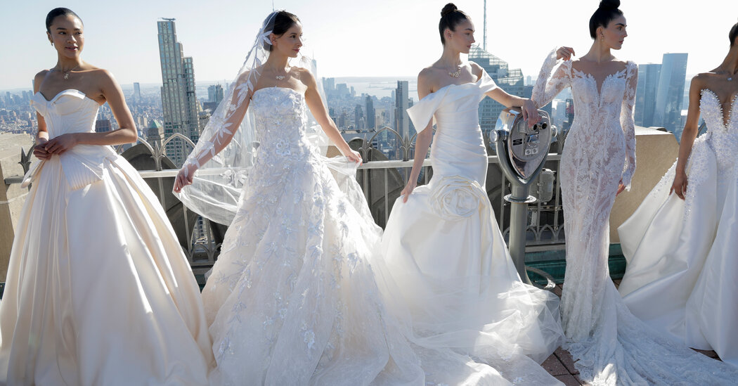 Models wearing gothic romance and nostalgic '90s inspired bridal gowns on the runway