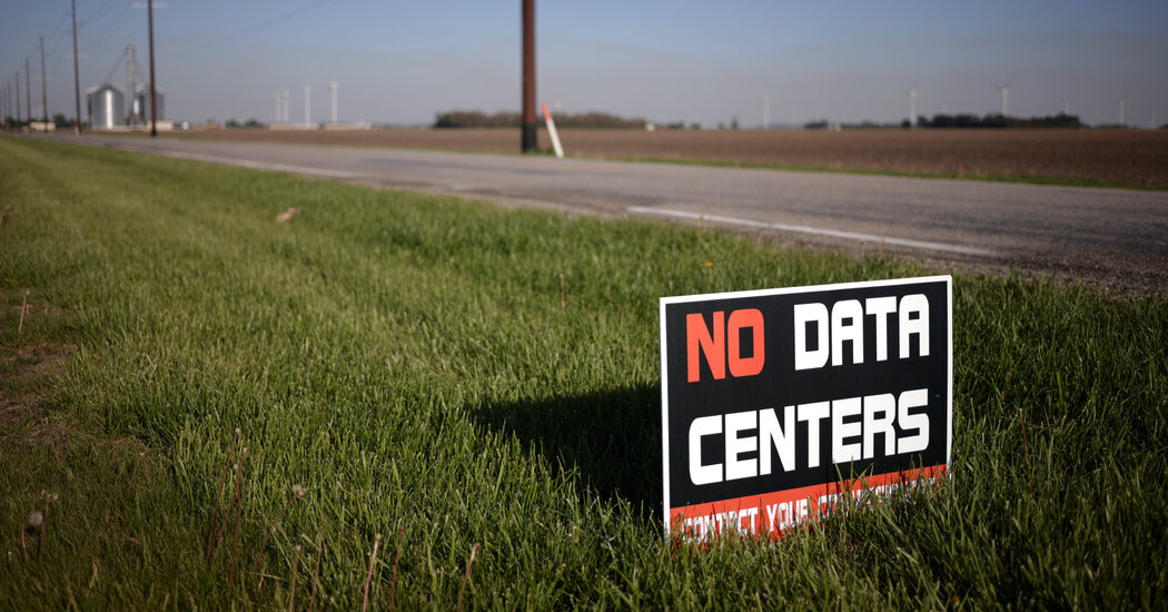 Protesters and community members gathered near an AI data center sign