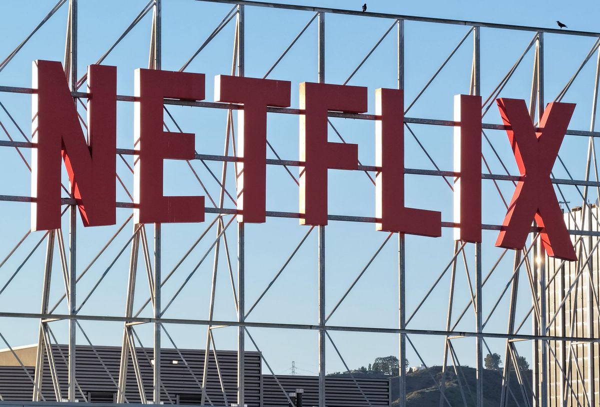 Netflix storefront with streaming app interface visible on a smartphone
