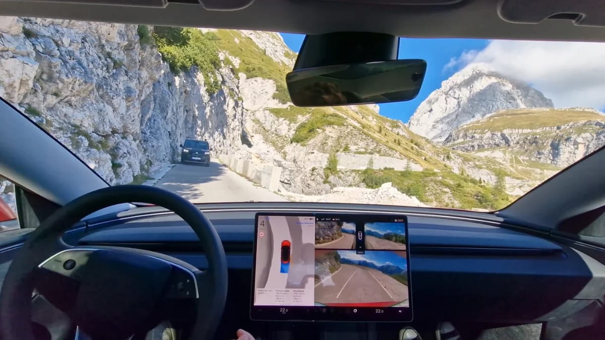 Tesla Model 3 Highland autonomous vehicle on narrow mountain road