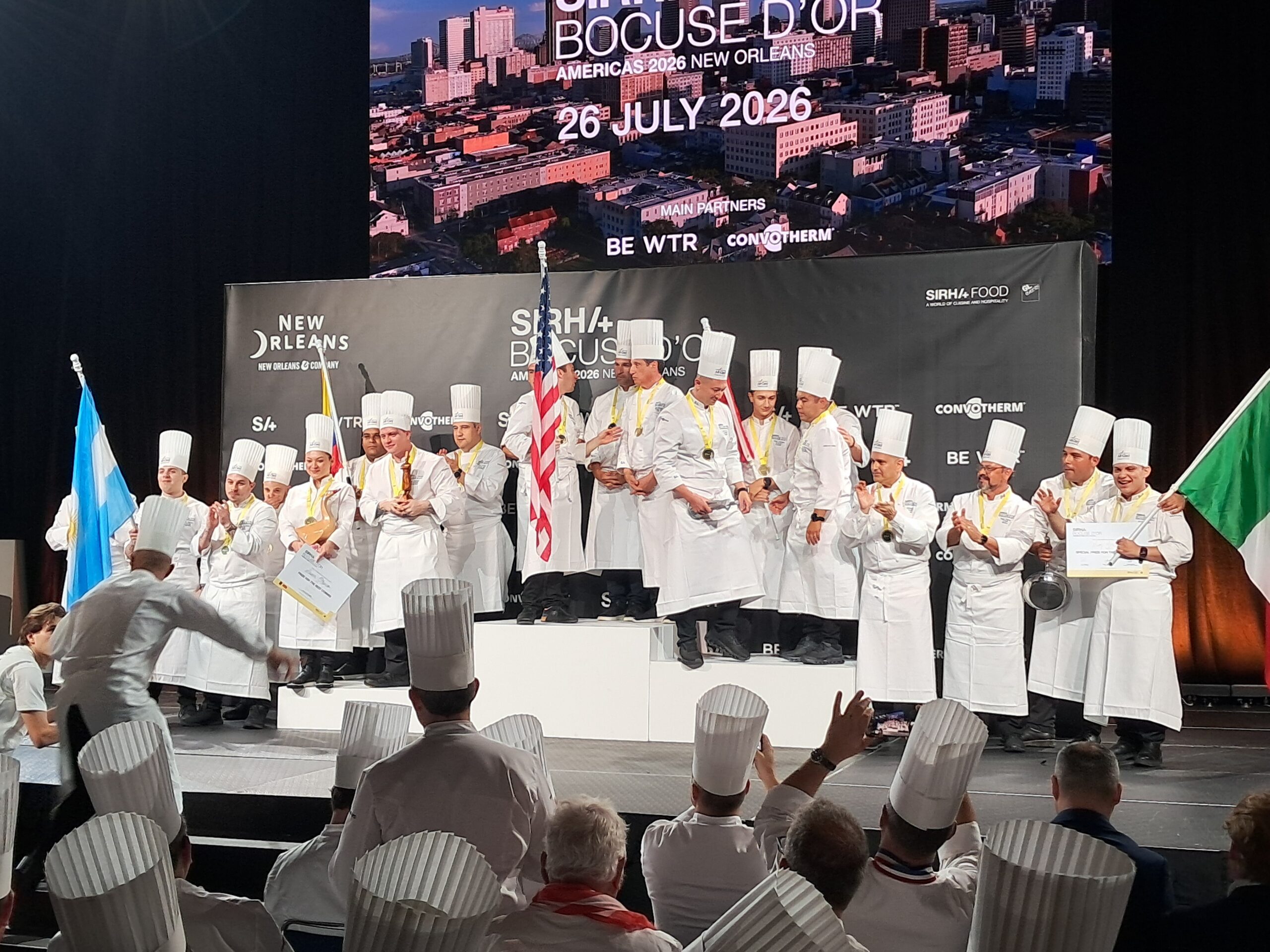 Chefs celebrating a victory at the Bocuse d'Or or Pastry World Cup Americas selection in New Orleans