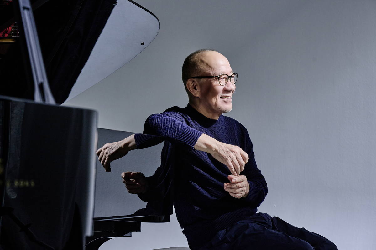 Joe Hisaishi conducting an orchestra