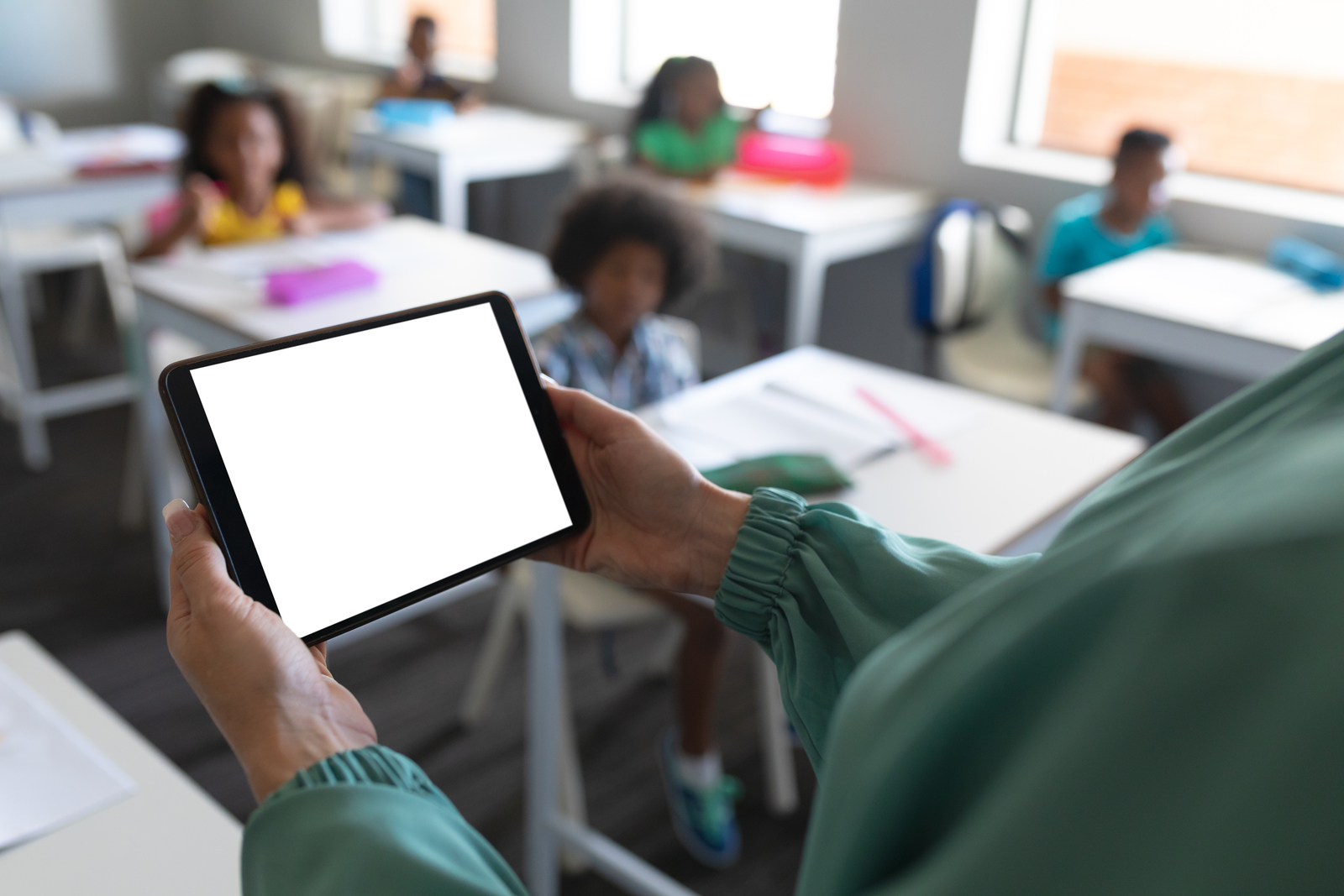 Photo of a student using a tablet in a classroom setting