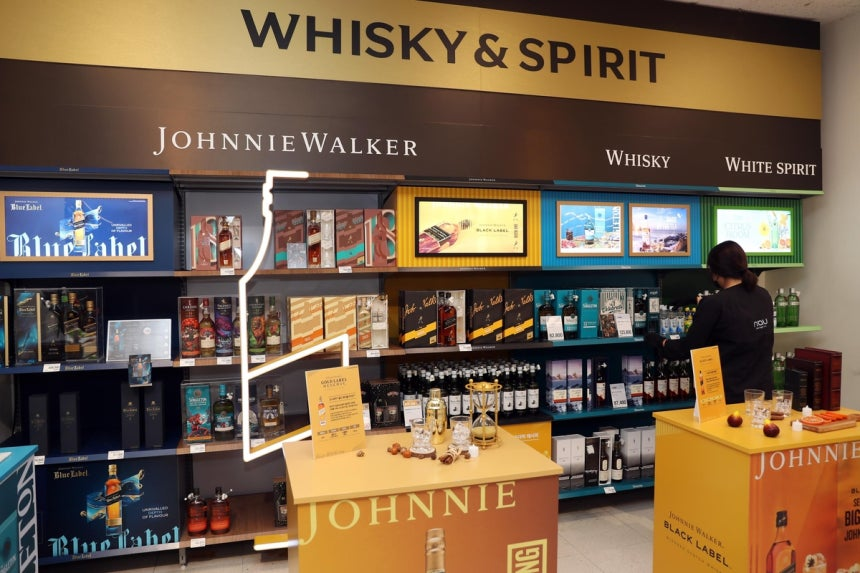 Whiskey bottles and soju bottles displayed on a shelf