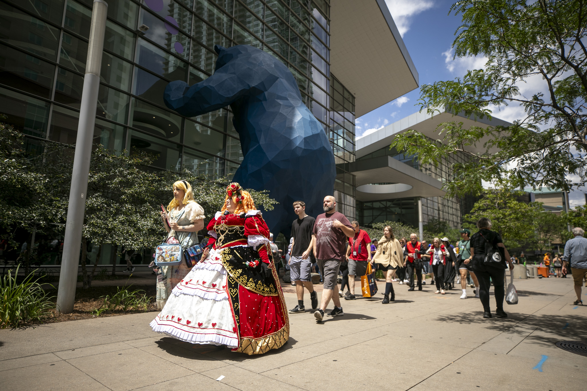 Cosplayers in elaborate costumes at Fan Expo Denver convention floor