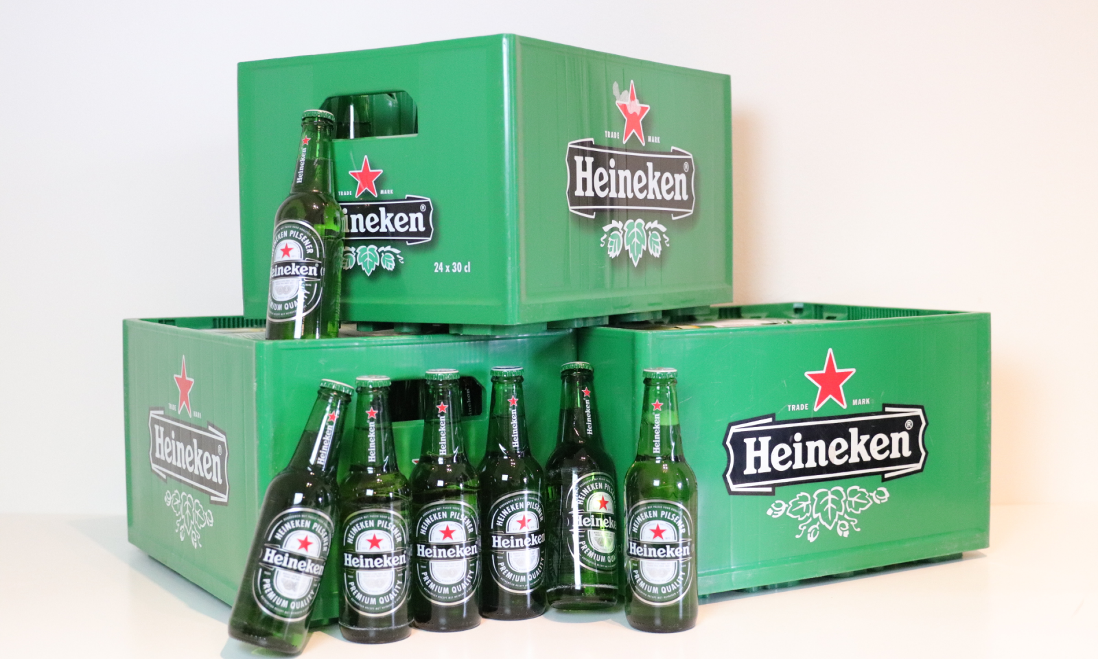 Heineken beer bottles and crates on a white background