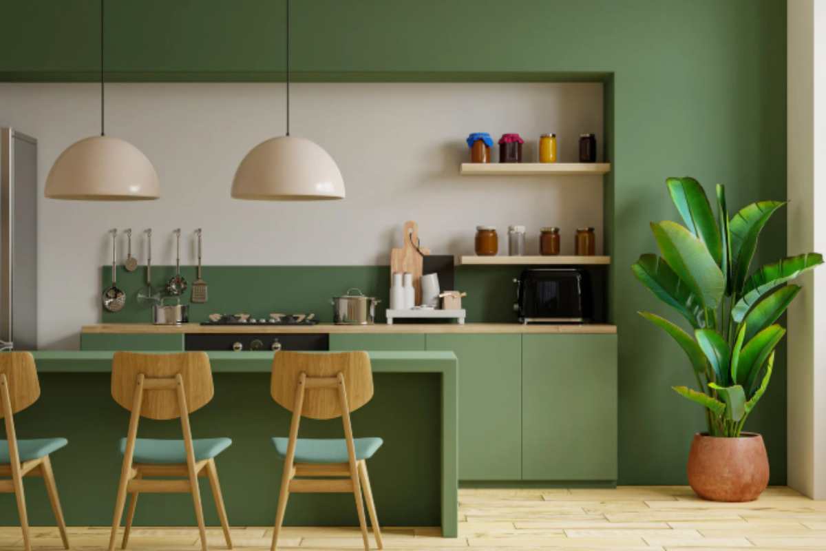 Kitchen interior featuring forest green cabinetry and dark marble accents