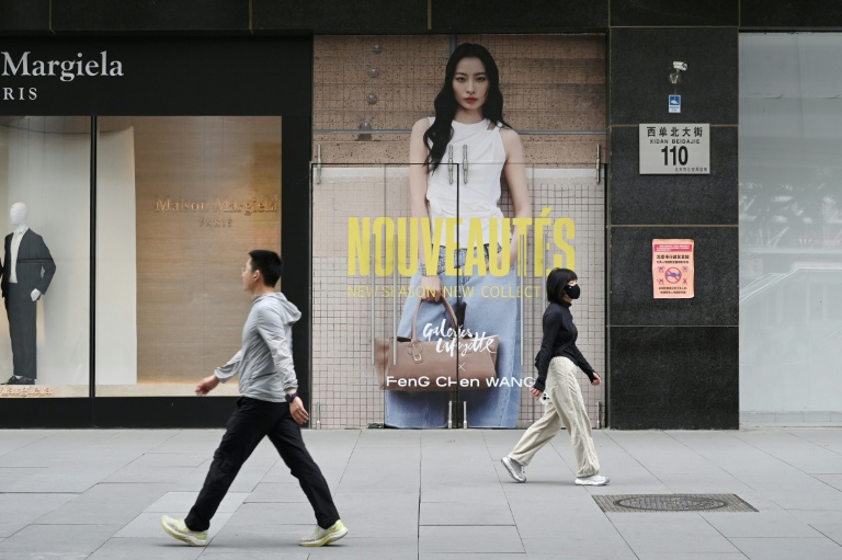 Beijing luxury retail shift — shoppers walk past a closing Galeries Lafayette in May 2026
