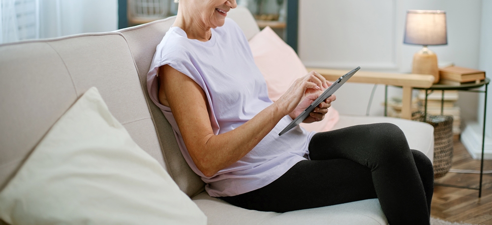 Elderly woman looking at health tracking on a digital tablet