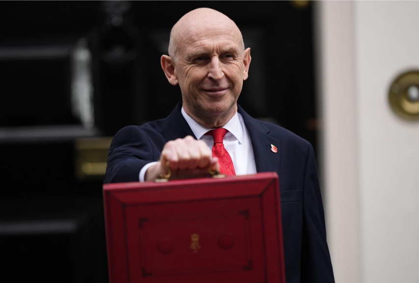 Chancellor with red briefcase in hand
