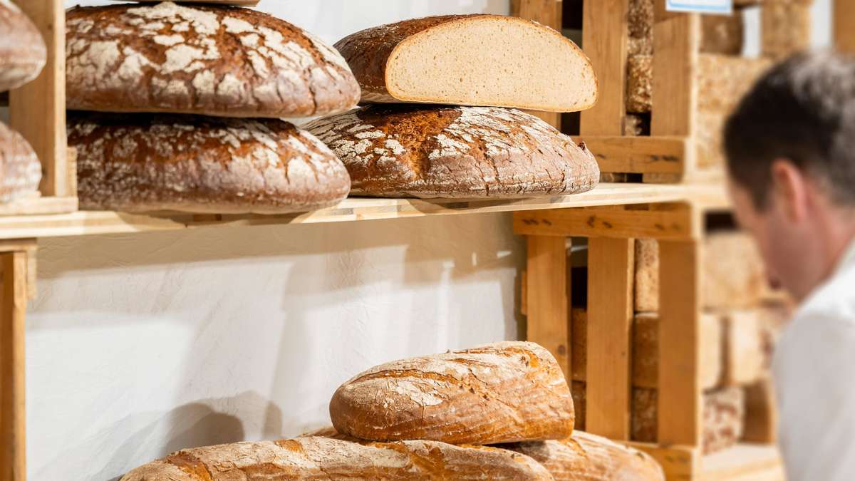 Freshly baked loaves on wooden shelves in a German artisan bakery
