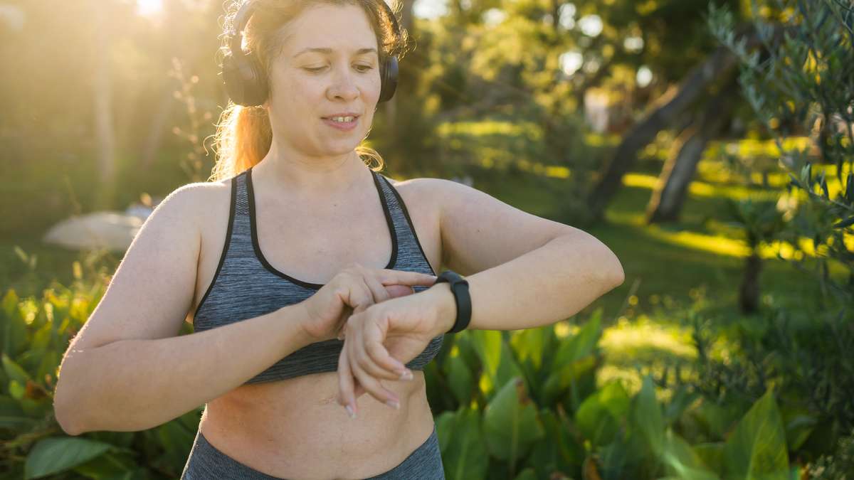Fitness tracker on a jogger's wrist illustrating wearable tech trends