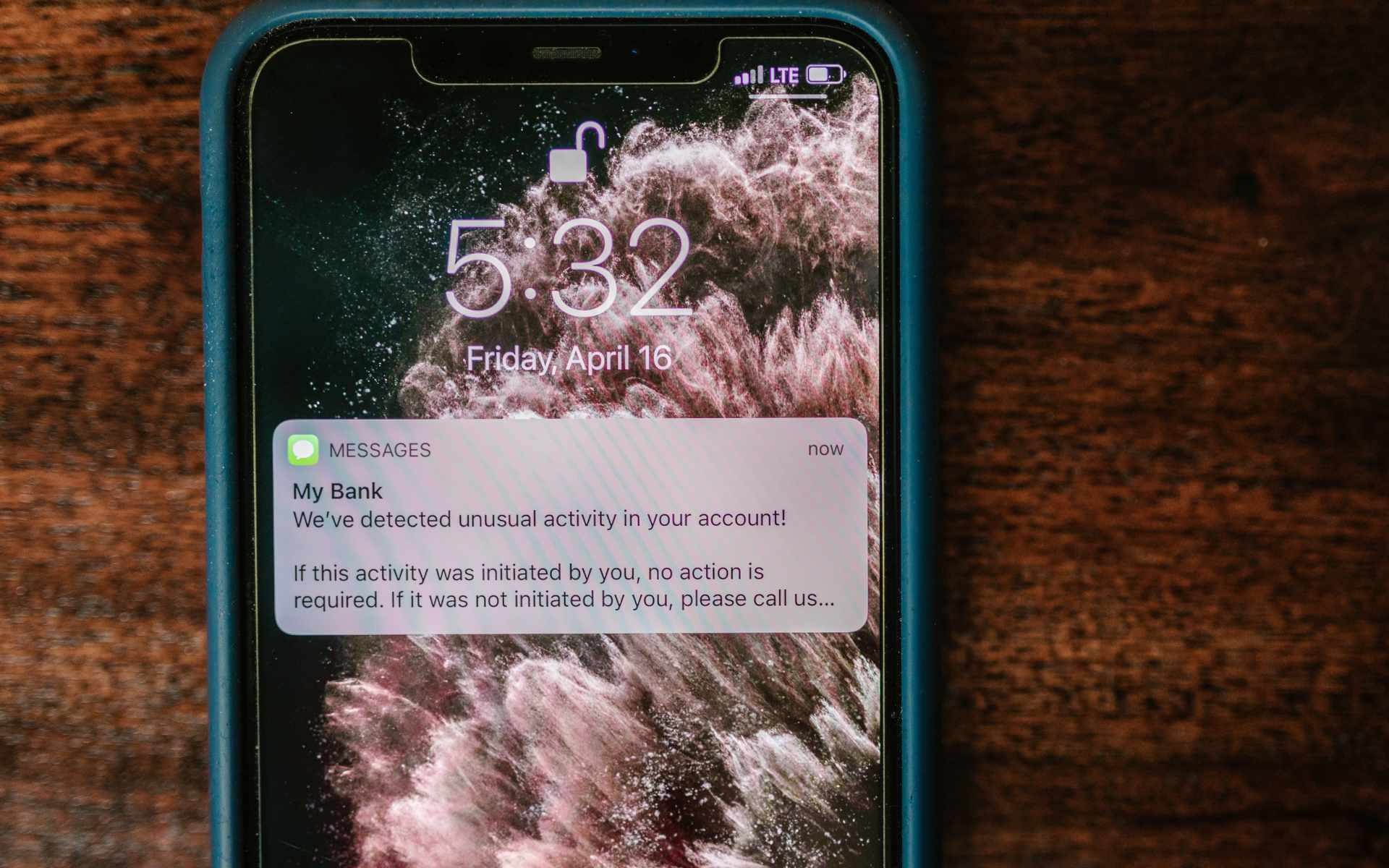 Phishing SMS alert on smartphone regarding unusual bank activity