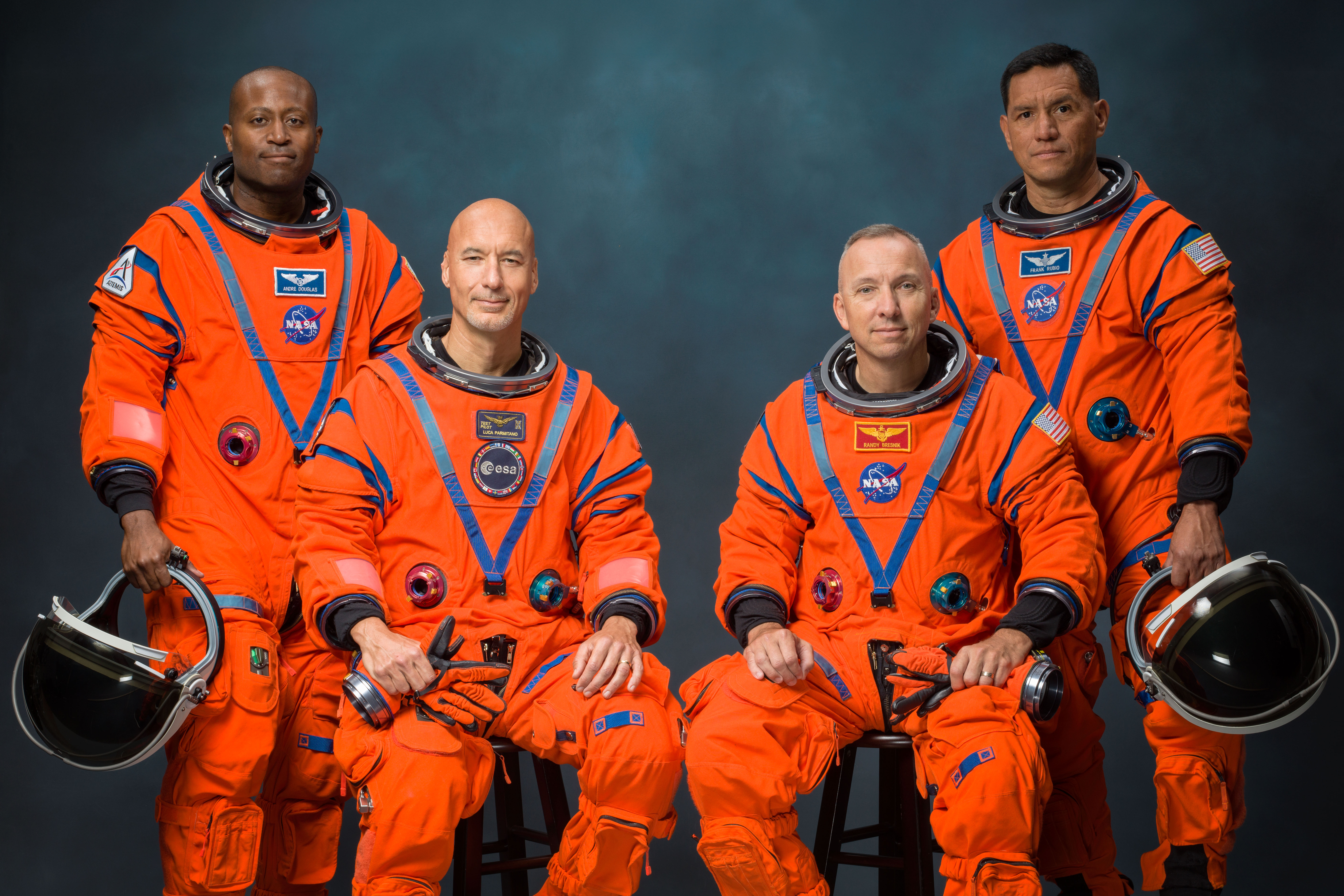 Four Artemis III astronauts stand together in official NASA portrait