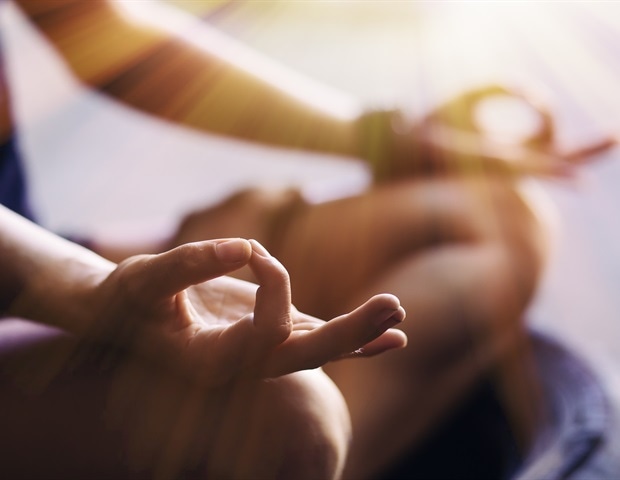 Closeup of woman's hands meditating indoors
