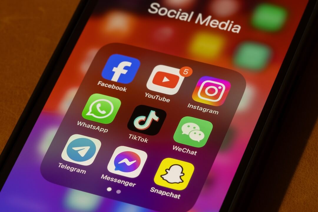 Illustration of social media icons on a smartphone screen representing new teen restrictions