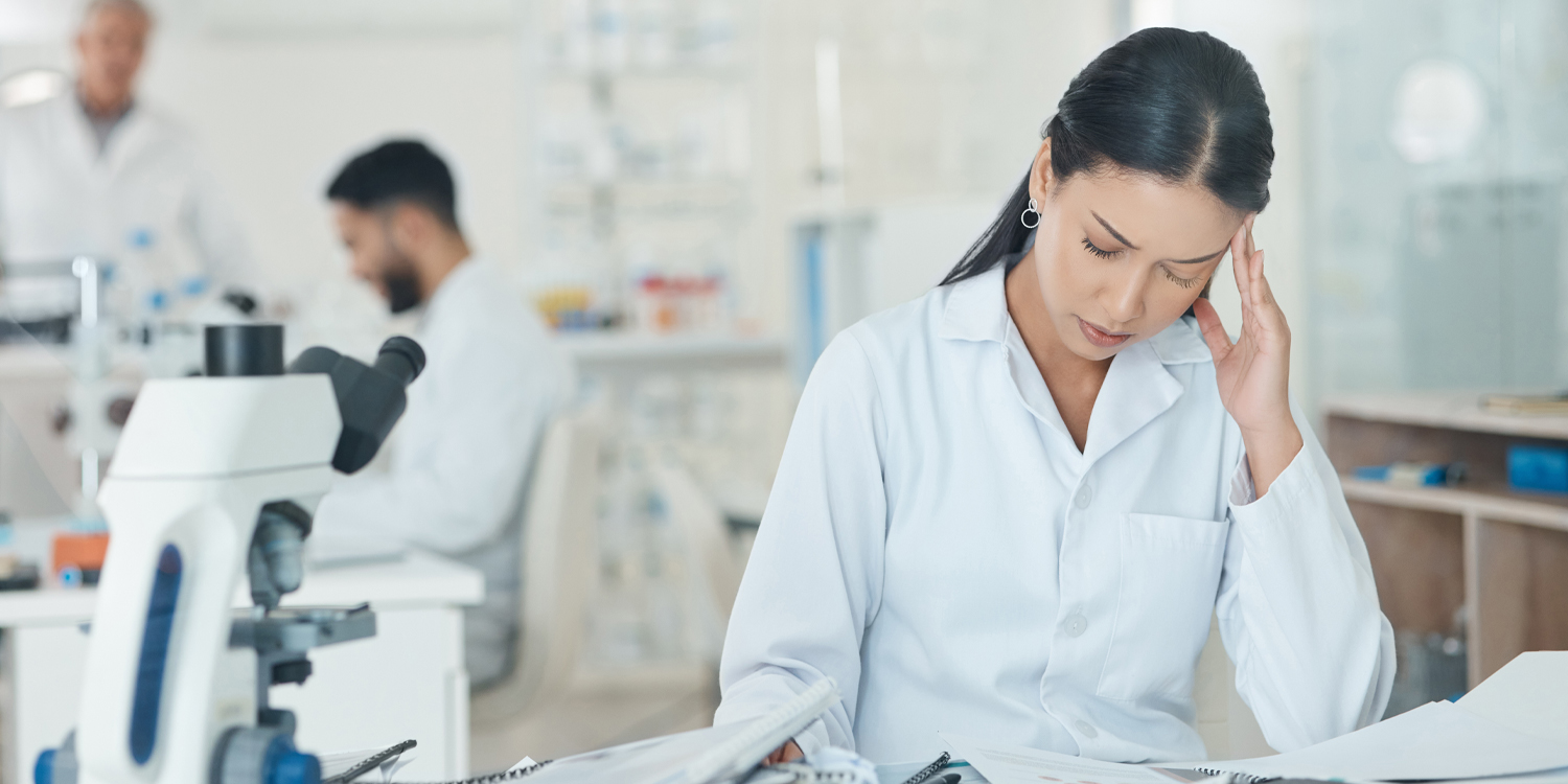 Stressed scientist contemplating career future amid funding cuts