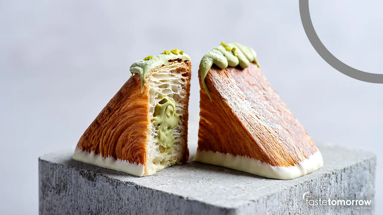 Colorful ube croissants glazed and topped with coconut