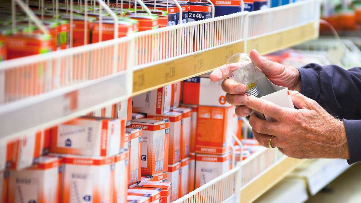 A shopper looking at light bulbs in a DIY store