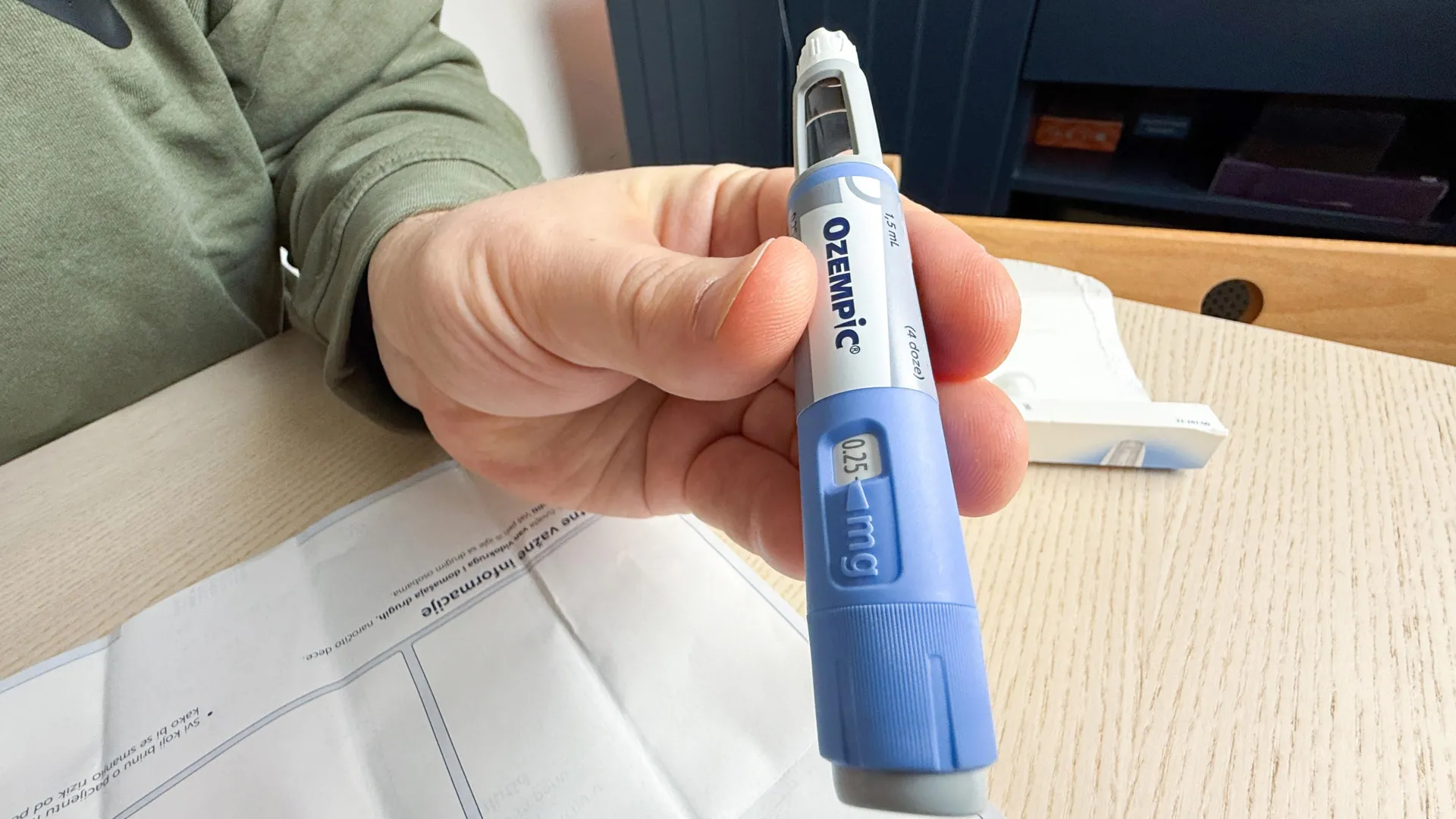 Close-up of a hand holding a GLP-1 semaglutide injection pen