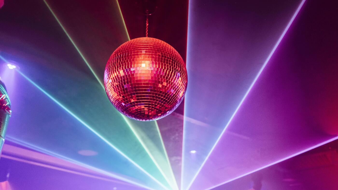 Disco ball under red neon light in a Berlin nightclub