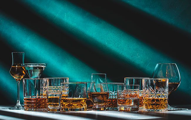 Cognac bottles displayed at a masters event