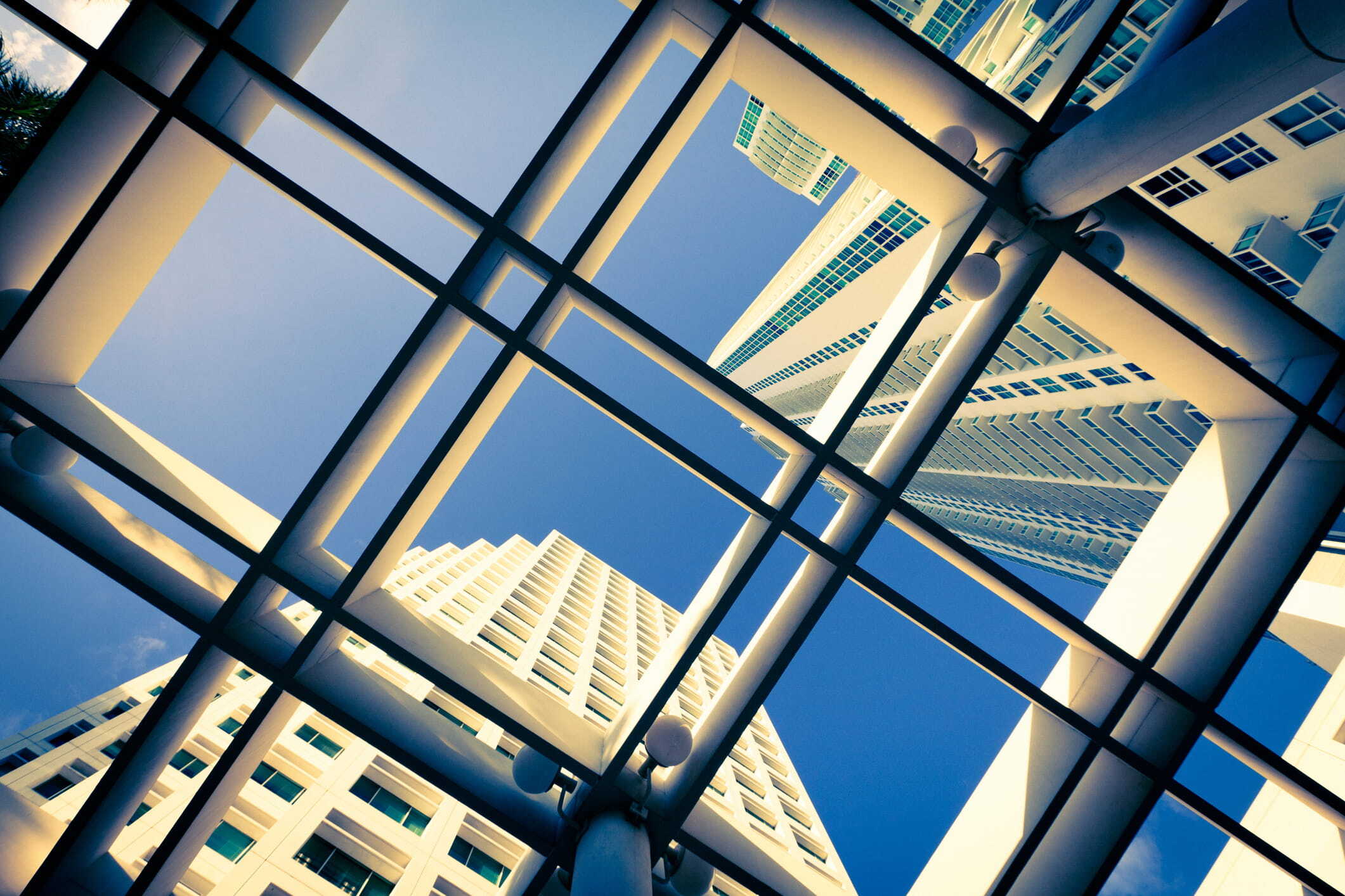 Abstract office and commercial real estate structures symbolizing delinquency pressures